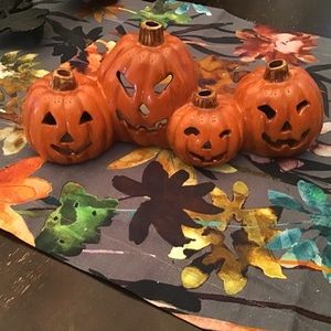Ceramic pumpkins hold battery operated tea light.